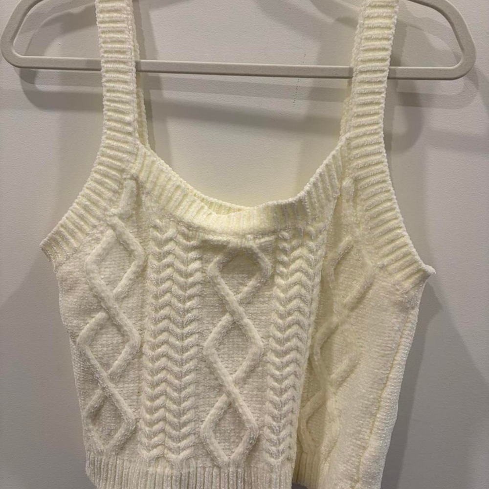 Cream cable knitted crop top with lace up back detail.